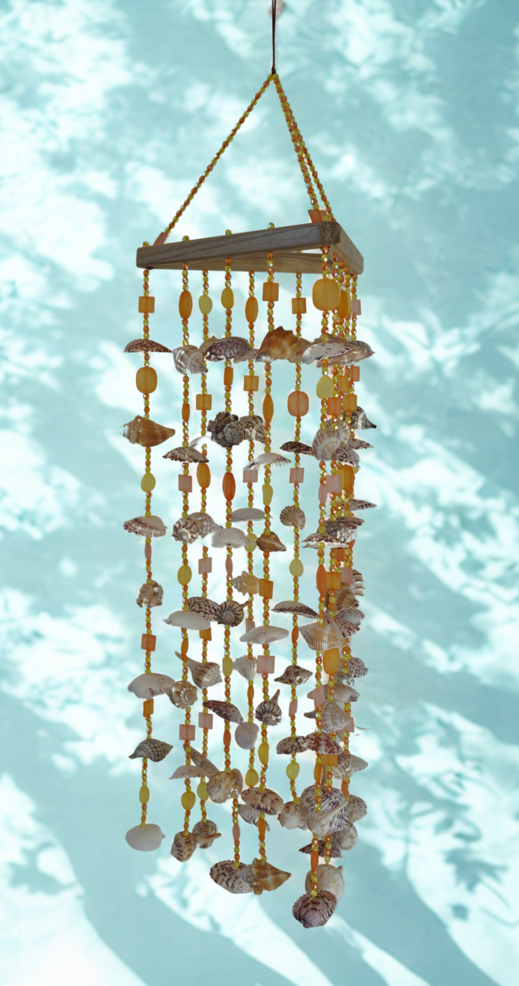 Decorative shell wind chime against a light blue background