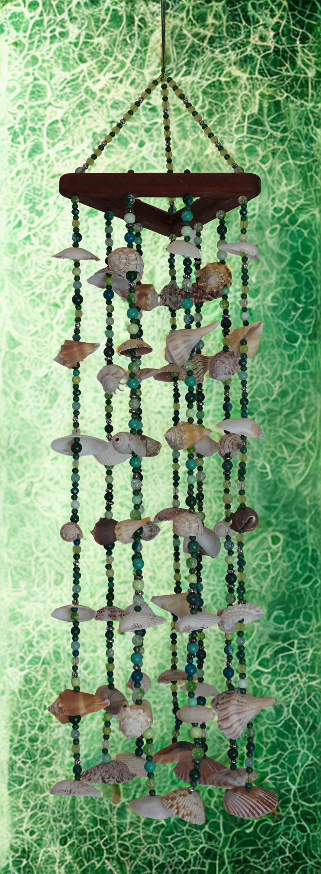 Decorative shell wind chime against a green textured background