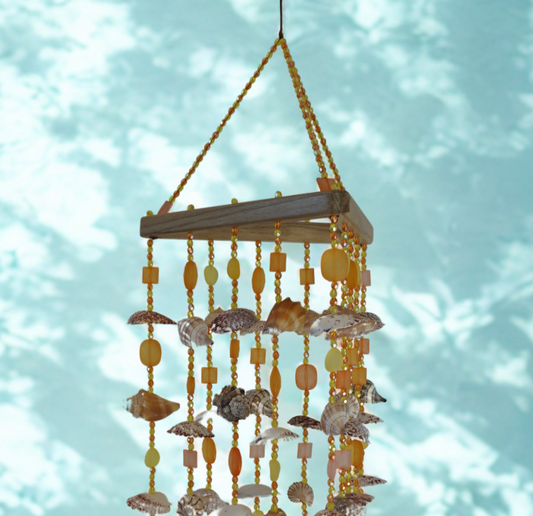 Decorative shell wind chime against a light blue background