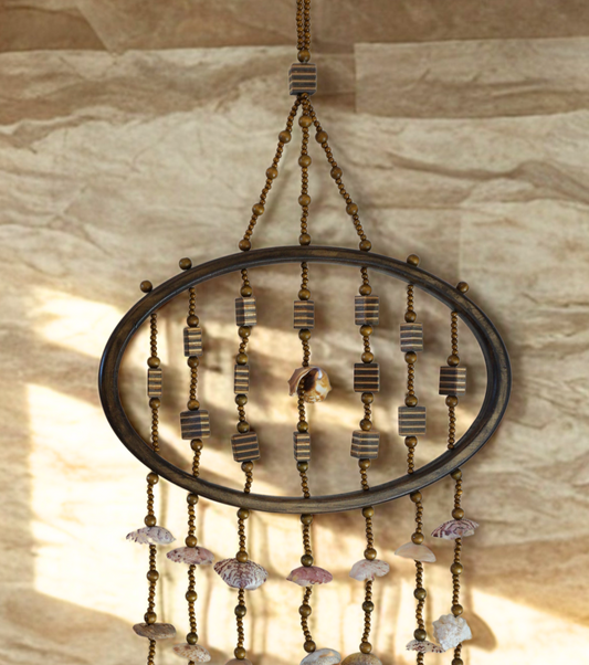 Decorative shell wall hanging against a wooden wall.