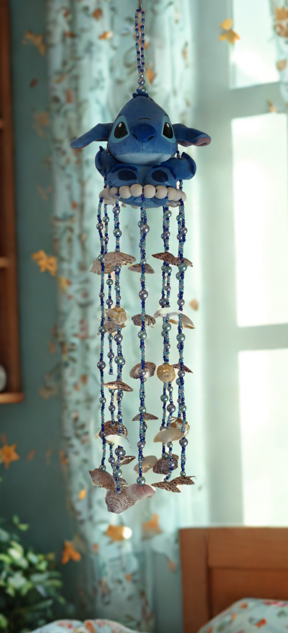 Decorative wind chime with blue character and shell elements in a room setting
