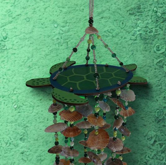Decorative turtle-shaped wind chime with shell and bead elements on a green textured background