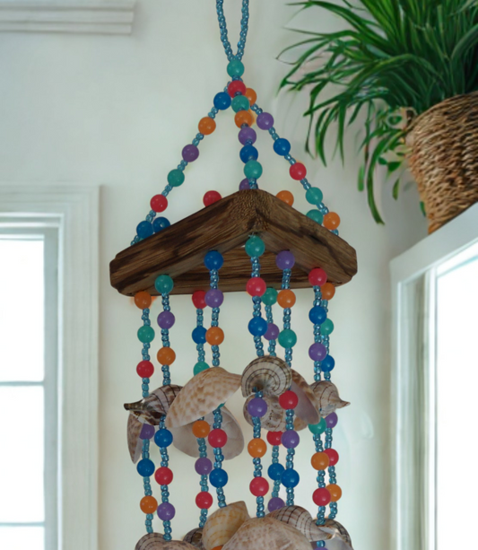 Decorative wind chime with colorful beads and shells hanging indoors.
