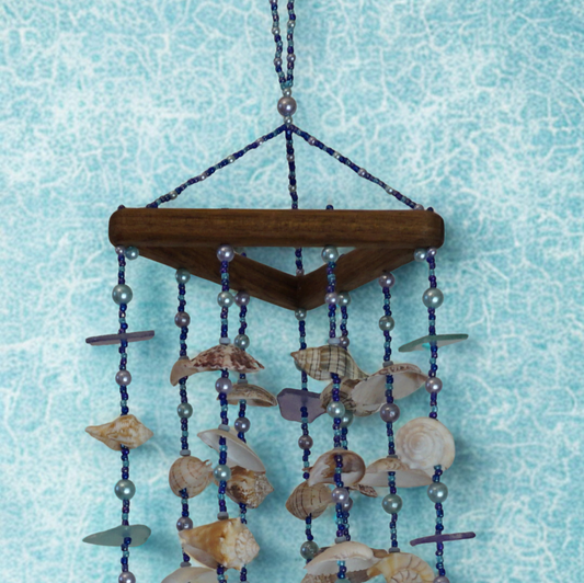 Decorative shell wind chime against a light blue background
