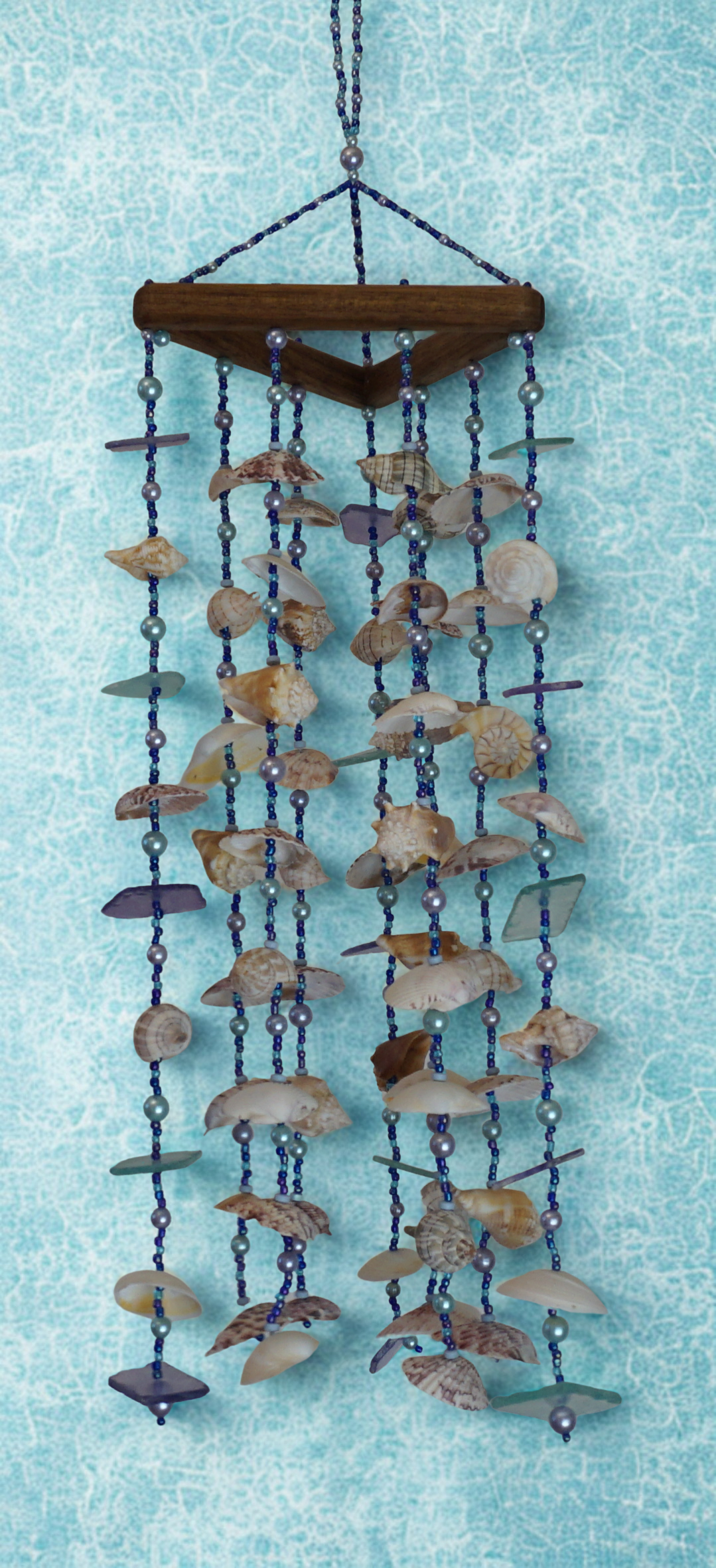 Decorative shell wind chime against a light blue background